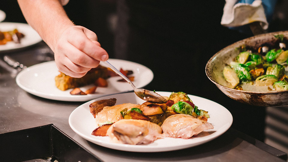 Chef putting food on a plate