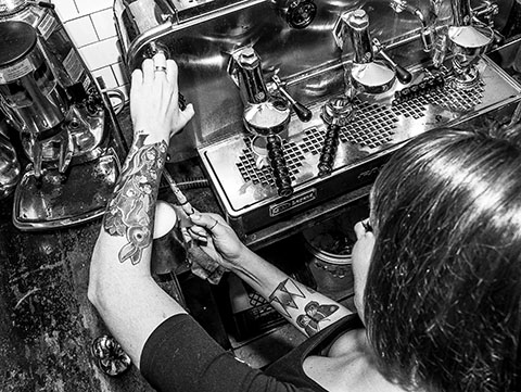 Girl making cappuccino